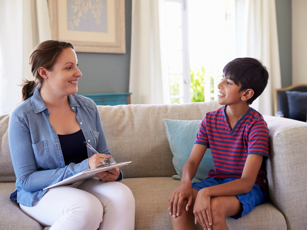 A photo a councillor talking with a youth.