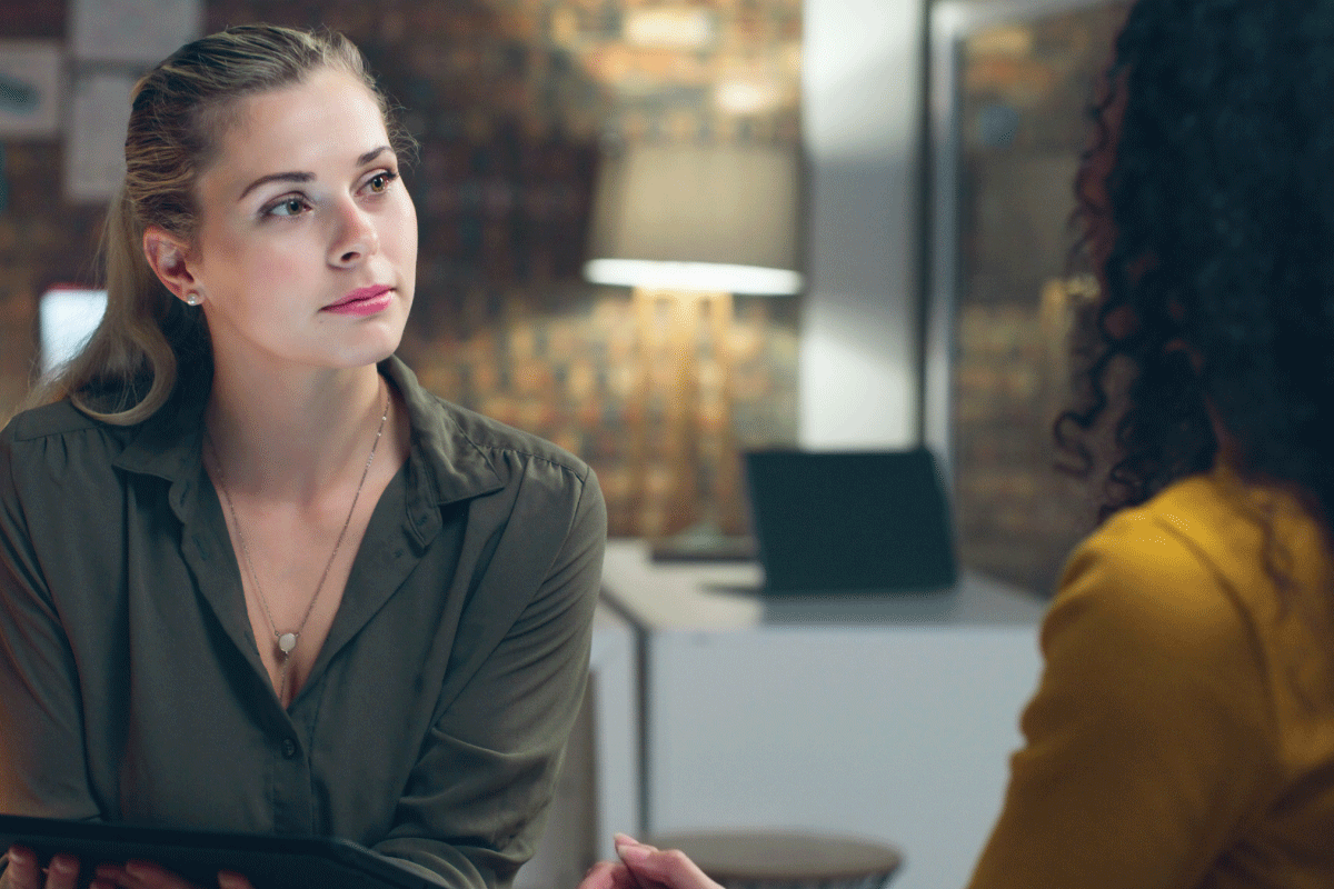 A photo of two people talking.