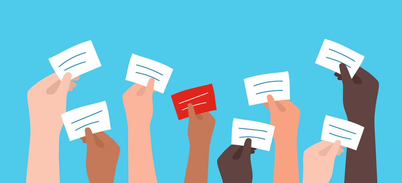 An illustration of hands holding up voting cards in the air.