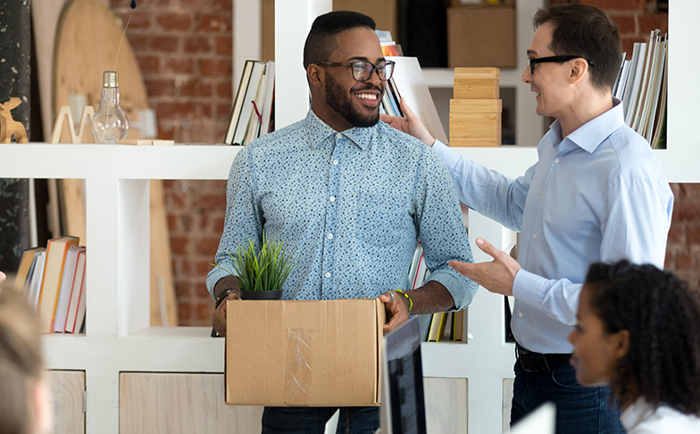 A photo of people moving some boxes.