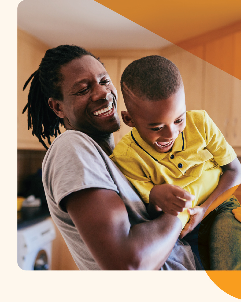 A photo of a dad enjoying time with his young son.