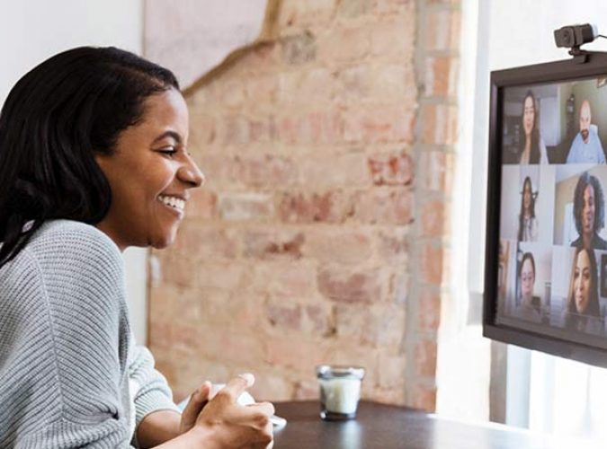 A photo of a woman working from home on a virtual conference call.